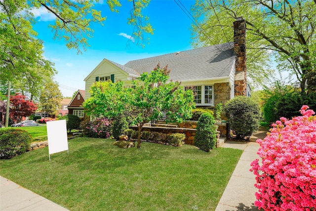 249Slosson Ave, Staten Island, NY 10314 - view of front of home featuring stone siding, roof with shingles, a chimney, and a front yard