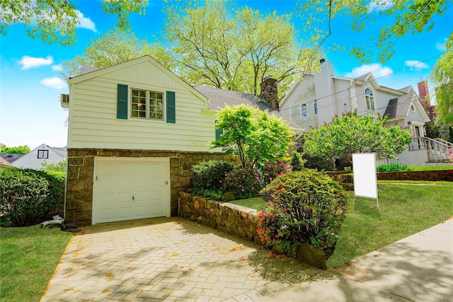 249Slosson Ave, Staten Island, NY 10314 - view of front of house with stone siding, a garage, a chimney, decorative driveway, and a front yard