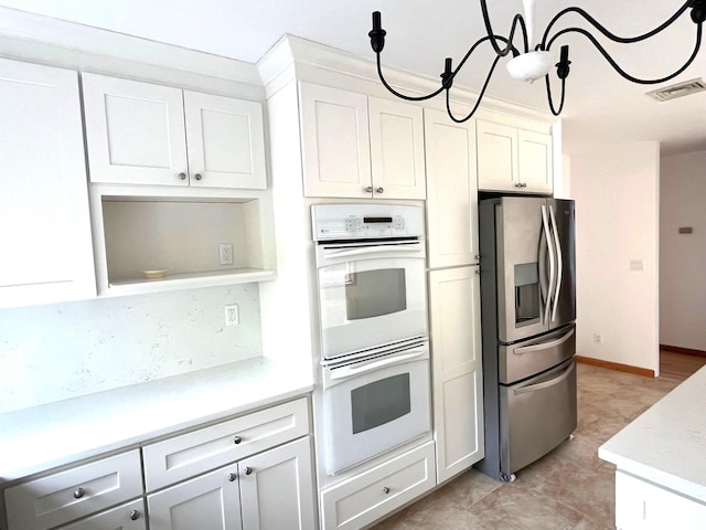36 Ridgetop Dr, Tomkins Cove, NY 10986 - kitchen with stainless steel fridge, white double oven, white cabinets, and tasteful backsplash