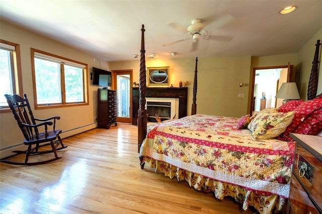 36 Ridgetop Dr, Tomkins Cove, NY 10986 - bedroom with light wood-style floors, recessed lighting, a glass covered fireplace, and a ceiling fan