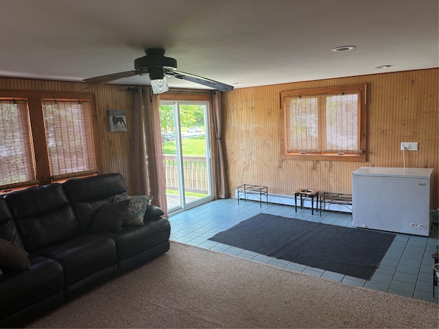 56 Martin Dr, Wappingers Falls, NY 12590 - tiled living room featuring wooden walls, ceiling fan, and a baseboard radiator