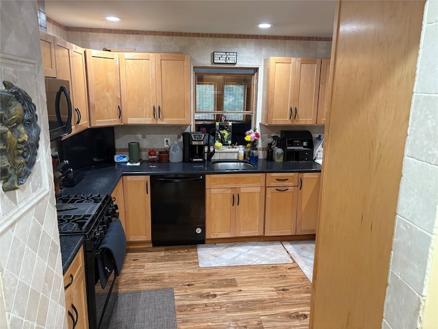 56 Martin Dr, Wappingers Falls, NY 12590 - kitchen with black appliances, dark countertops, light wood-type flooring, and a sink