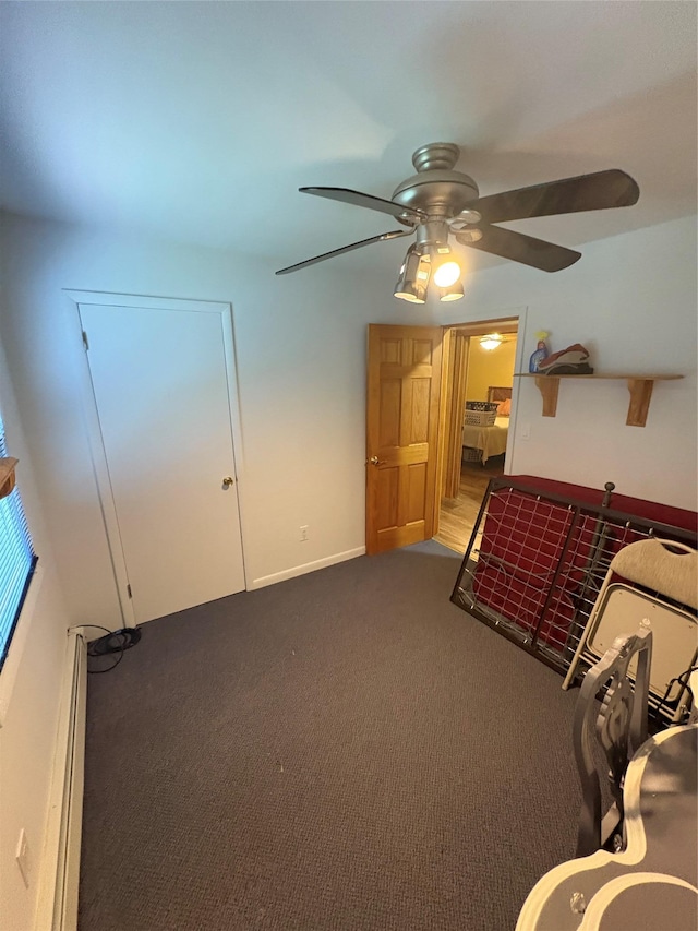 56 Martin Dr, Wappingers Falls, NY 12590 - unfurnished bedroom with baseboard heating, carpet, and a ceiling fan