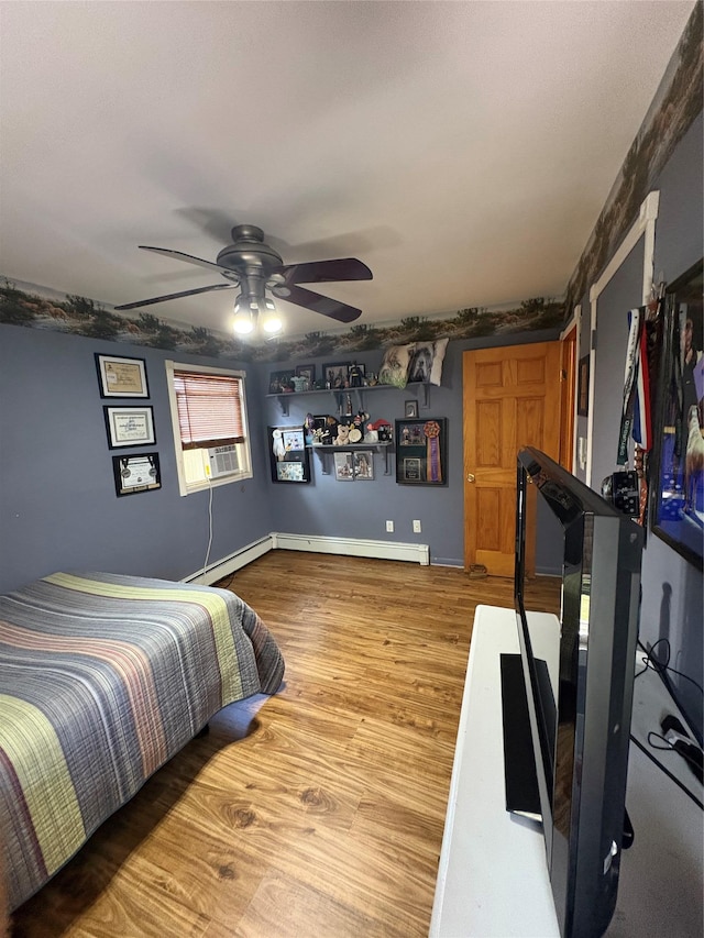 56 Martin Dr, Wappingers Falls, NY 12590 - bedroom with wood finished floors, a baseboard radiator, cooling unit, and ceiling fan