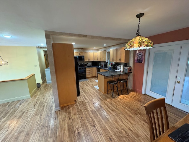 56 Martin Dr, Wappingers Falls, NY 12590 - kitchen with black appliances, a peninsula, dark countertops, light wood finished floors, and recessed lighting