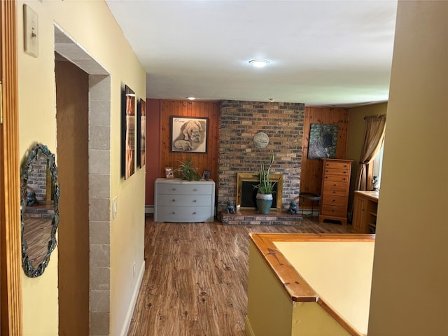 56 Martin Dr, Wappingers Falls, NY 12590 - living room featuring wood finished floors, a brick fireplace, and wooden walls
