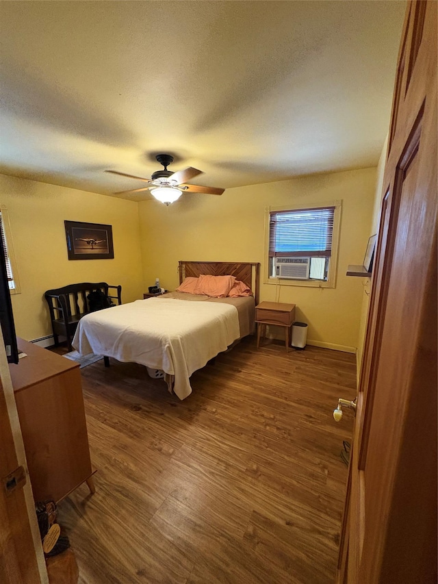 56 Martin Dr, Wappingers Falls, NY 12590 - bedroom with dark wood-type flooring, a textured ceiling, a ceiling fan, cooling unit, and baseboards