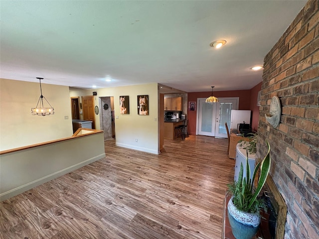 56 Martin Dr, Wappingers Falls, NY 12590 - unfurnished living room with wood finished floors, baseboards, and a chandelier