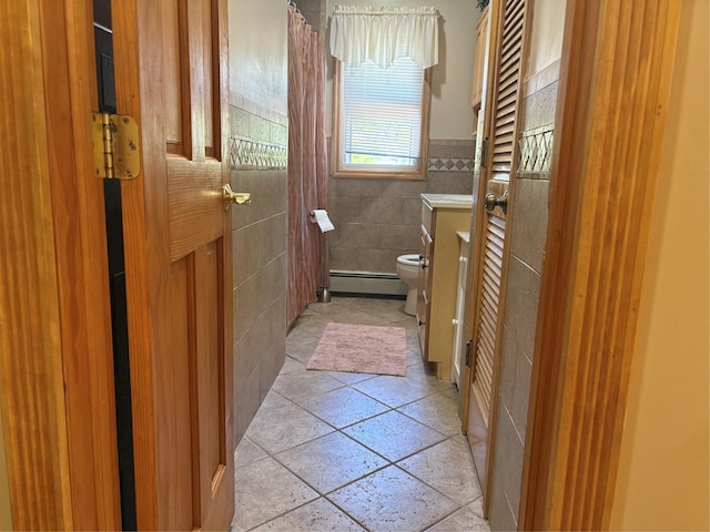 56 Martin Dr, Wappingers Falls, NY 12590 - bathroom featuring baseboard heating, toilet, tile walls, vanity, and curtained shower