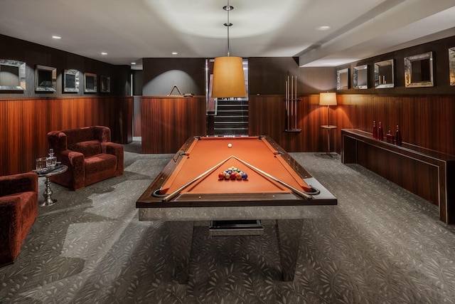 rec room with carpet flooring, pool table, and wooden walls