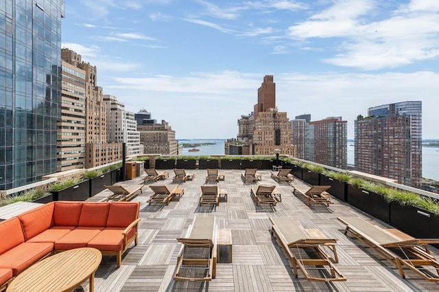 view of patio featuring a water view, a city view, and an outdoor hangout area