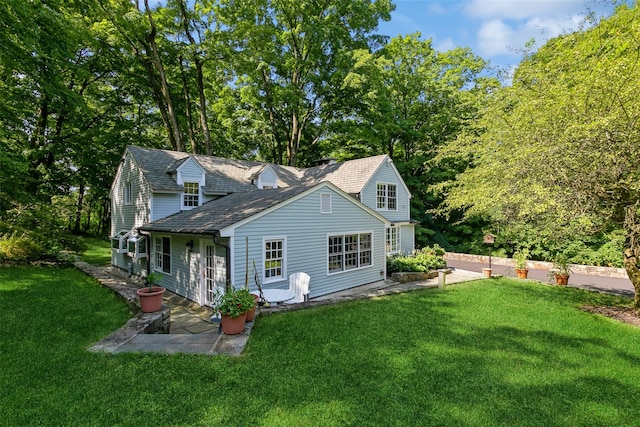 back of house with a yard and a patio area