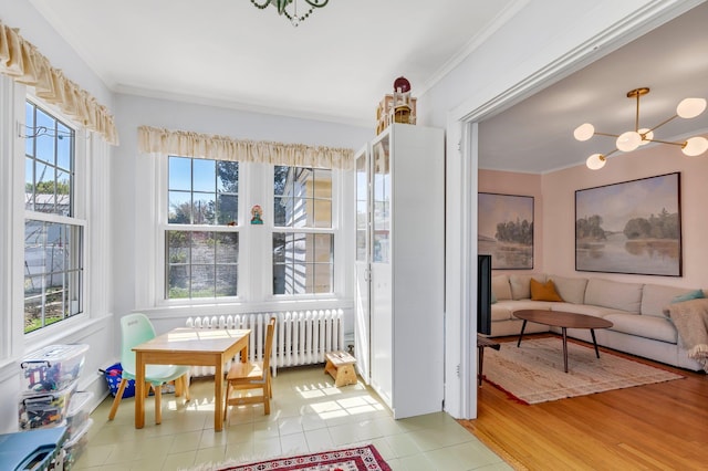 sunroom / solarium with an inviting chandelier and radiator heating unit