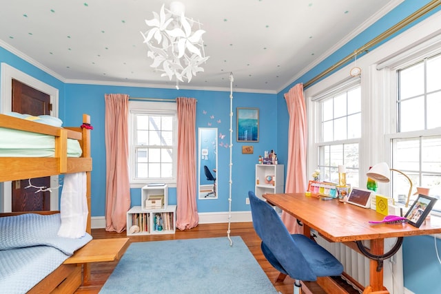 interior space featuring baseboards, ornamental molding, wood finished floors, and a chandelier