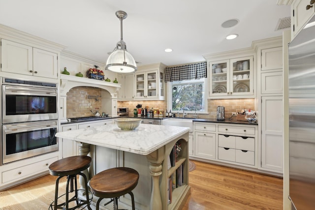 1325 Huckleberry Ln, Hewlett Harbor, NY 11557 - kitchen with appliances with stainless steel finishes, open shelves, tasteful backsplash, a center island, and recessed lighting