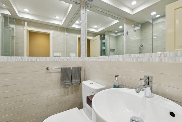 1325 Huckleberry Ln, Hewlett Harbor, NY 11557 - bathroom featuring a shower stall, tile walls, a sink, a tray ceiling, and toilet
