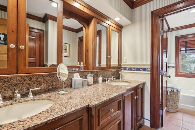 1325 Huckleberry Ln, Hewlett Harbor, NY 11557 - bathroom with wallpapered walls, ornamental molding, tile patterned floors, double vanity, and a tub to relax in