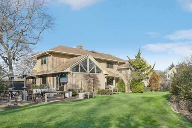 1325 Huckleberry Ln, Hewlett Harbor, NY 11557 - back of house with a patio, a chimney, a lawn, and a shingled roof