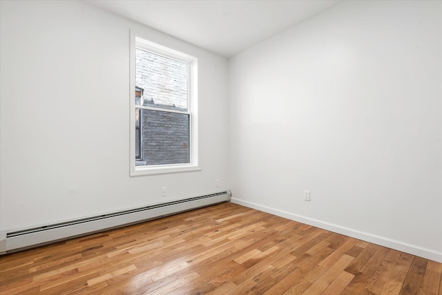 1236 Evergreen Ave, Bronx, NY 10472 - spare room with a baseboard radiator, light wood finished floors, and baseboards