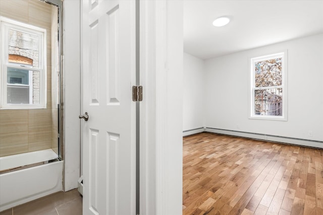 1236 Evergreen Ave, Bronx, NY 10472 - unfurnished room with a baseboard radiator and light wood finished floors