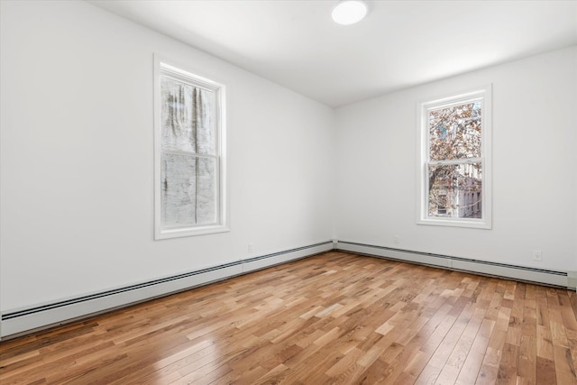 1236 Evergreen Ave, Bronx, NY 10472 - unfurnished room with a baseboard heating unit and light wood-style floors