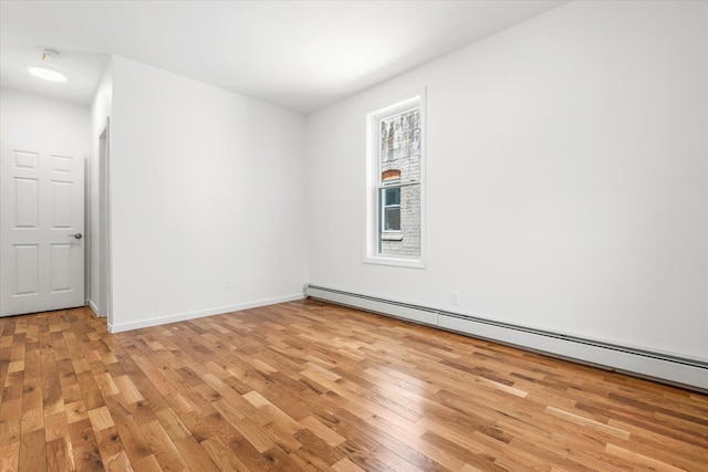 1236 Evergreen Ave, Bronx, NY 10472 - spare room featuring light wood-style flooring, baseboard heating, and baseboards