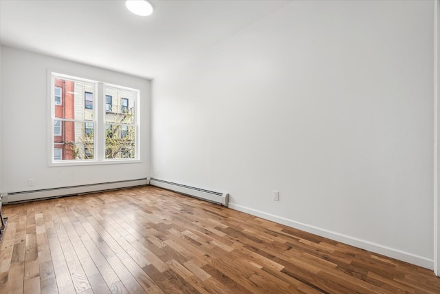 1236 Evergreen Ave, Bronx, NY 10472 - unfurnished room with wood finished floors, a baseboard heating unit, and baseboards