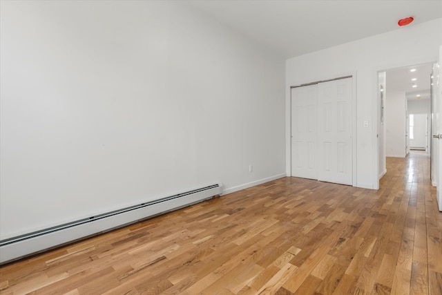 1236 Evergreen Ave, Bronx, NY 10472 - unfurnished bedroom with a baseboard radiator, light wood finished floors, a closet, baseboards, and recessed lighting