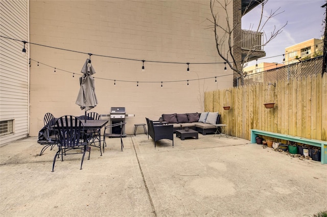 view of patio featuring an outdoor living space, outdoor dining area, and fence