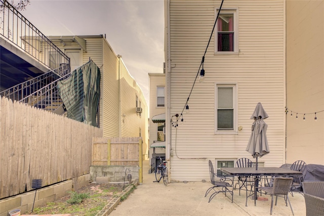 back of house with fence, outdoor dining area, and a patio area
