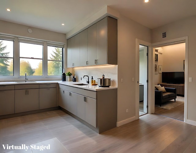 kitchen featuring a sink, light countertops, gray cabinets, recessed lighting, and visible vents