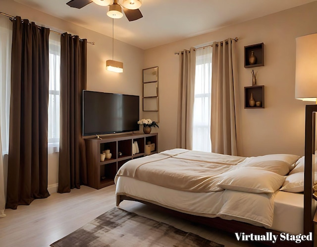 bedroom with ceiling fan and light wood-type flooring
