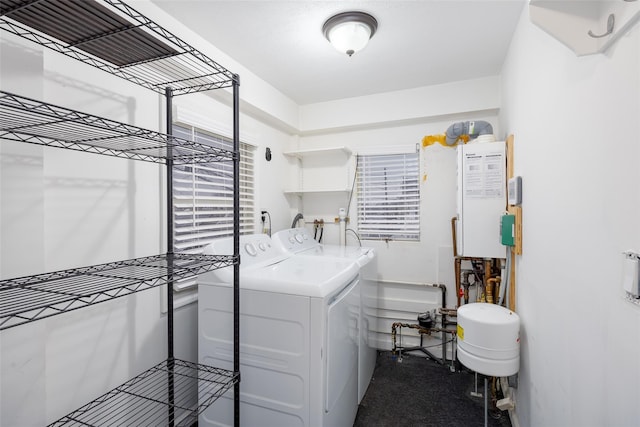 clothes washing area featuring laundry area and washer and clothes dryer