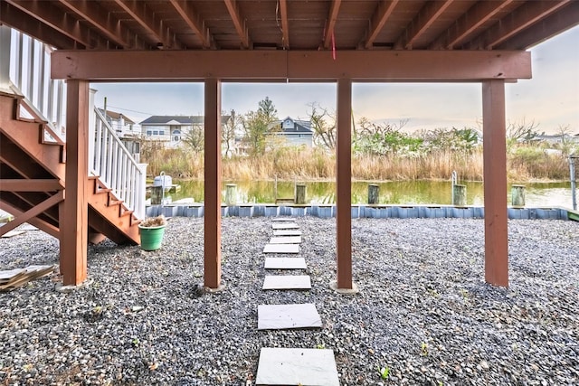 view of yard featuring stairs and a water view