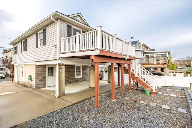 view of home's exterior with stairway, a patio area, and a deck