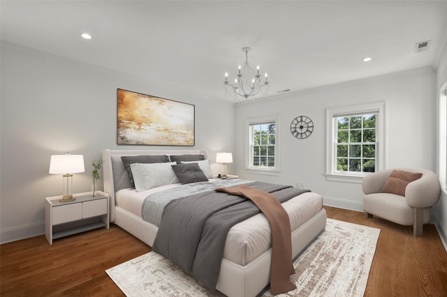 bedroom featuring wood finished floors, recessed lighting, crown molding, a chandelier, and baseboards