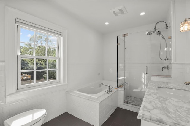 bathroom featuring a stall shower, recessed lighting, toilet, visible vents, and a garden tub