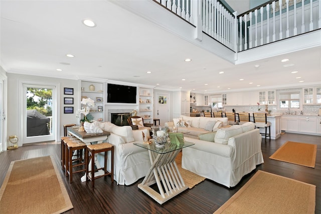879 Oceanfront, Long Beach, NY 11561 - living area featuring recessed lighting, crown molding, a glass covered fireplace, and dark wood finished floors