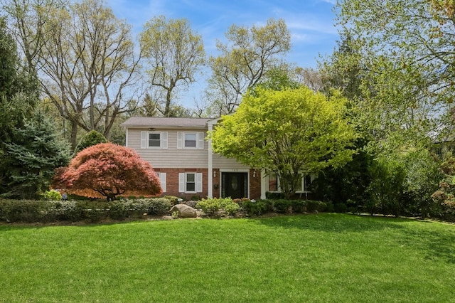 165 Tara Dr, Roslyn, NY 11576 - view of front facade with a front lawn and brick siding