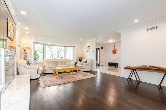 165 Tara Dr, Roslyn, NY 11576 - living area with wood finished floors, ornamental molding, recessed lighting, and baseboards