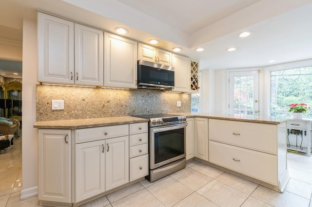 165 Tara Dr, Roslyn, NY 11576 - kitchen featuring stainless steel appliances, recessed lighting, backsplash, a peninsula, and light tile patterned floors