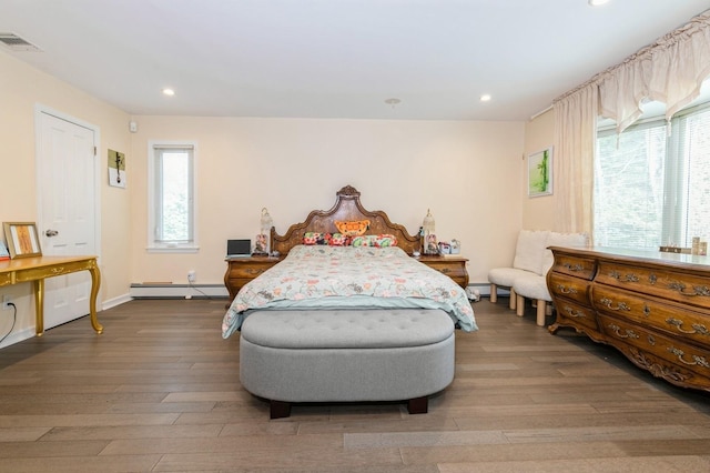 165 Tara Dr, Roslyn, NY 11576 - bedroom with baseboard heating, wood-type flooring, recessed lighting, and baseboards
