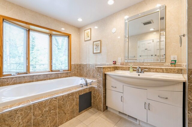 165 Tara Dr, Roslyn, NY 11576 - bathroom featuring tile patterned floors, a bath, vanity, recessed lighting, and tile walls