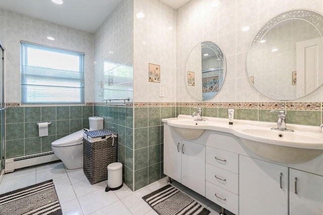 165 Tara Dr, Roslyn, NY 11576 - bathroom with tile walls, a baseboard radiator, tile patterned flooring, double vanity, and toilet