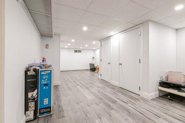 165 Tara Dr, Roslyn, NY 11576 - finished below grade area featuring wood finished floors, recessed lighting, baseboards, and a drop ceiling