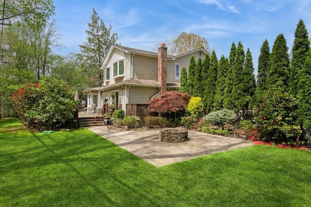 165 Tara Dr, Roslyn, NY 11576 - view of property exterior with an outdoor fire pit, a chimney, a deck, and a yard
