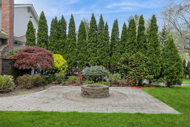 165 Tara Dr, Roslyn, NY 11576 - view of grassy yard with a fire pit and a patio