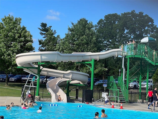 165 Tara Dr, Roslyn, NY 11576 - community pool featuring a water slide and fence