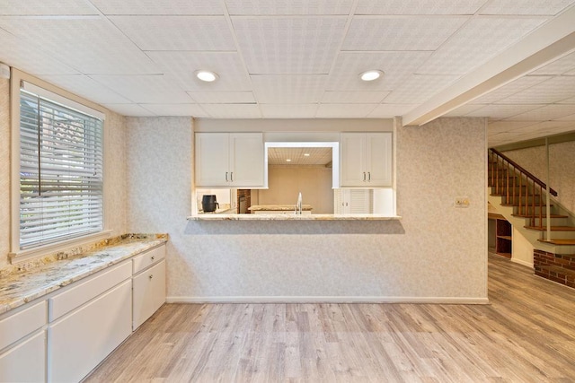 51 Strong Rd, Ferndale, NY 12734 - kitchen with white cabinetry, baseboards, a sink, and light wood-style floors