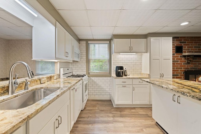 51 Strong Rd, Ferndale, NY 12734 - kitchen featuring white appliances, white cabinets, a drop ceiling, and a sink